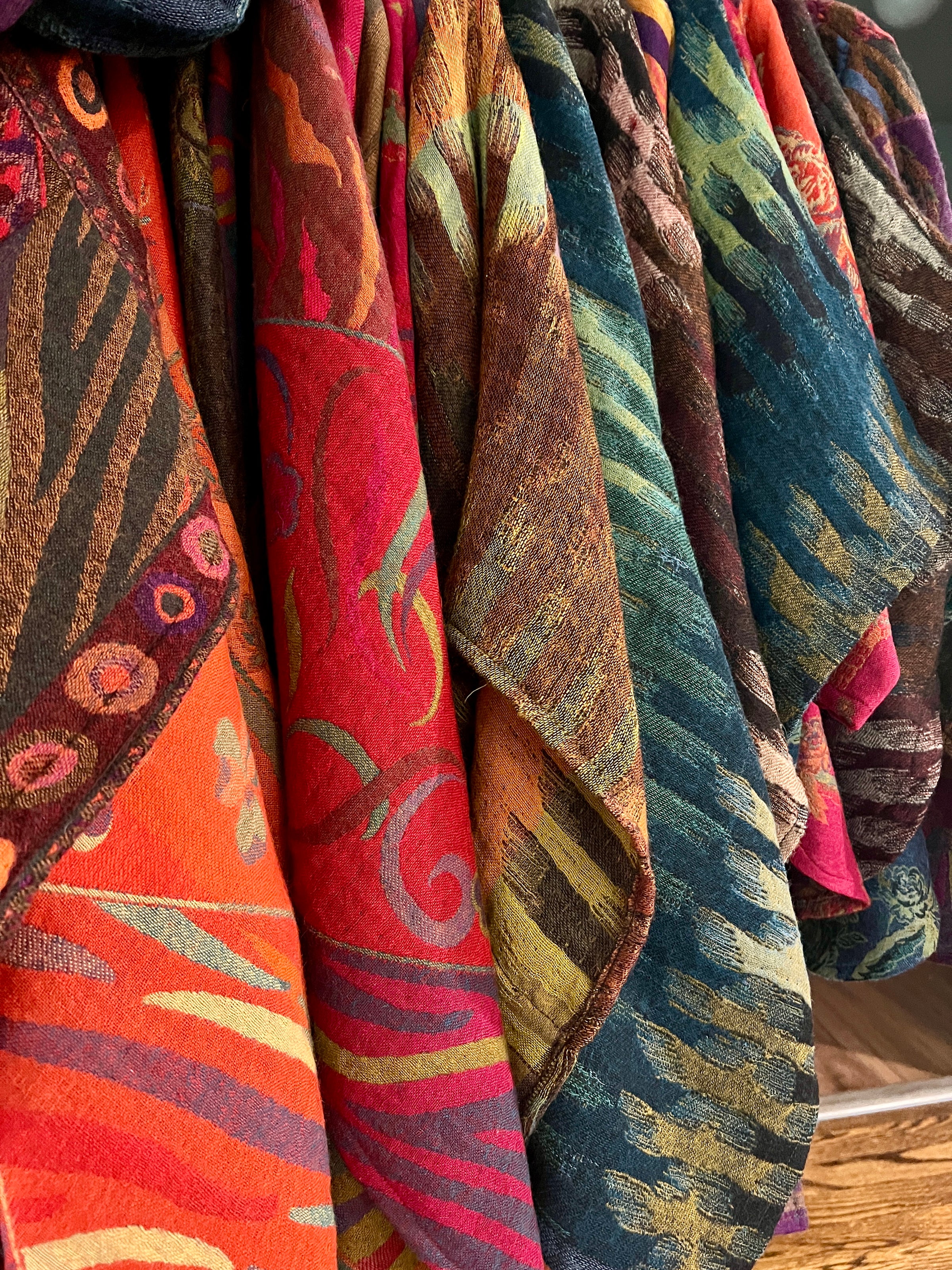 Colorful patterned fabric hanging on a rack